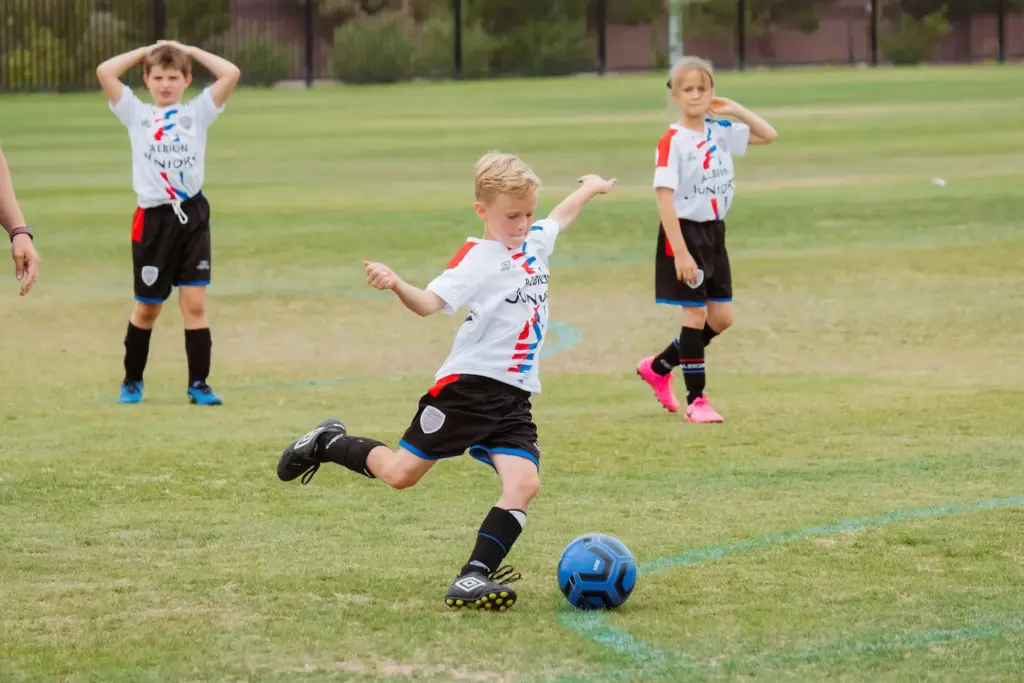 Young Children playing football